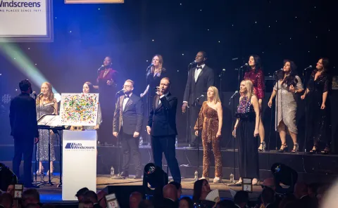 People on stage singing